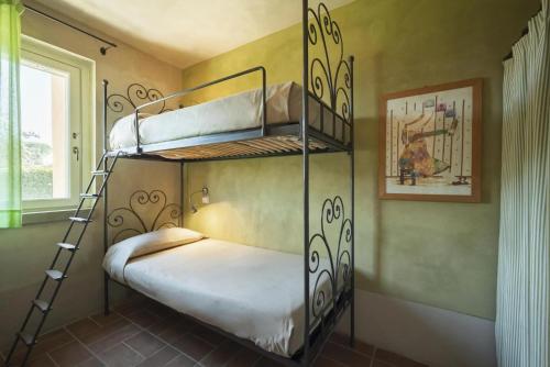 a bedroom with two bunk beds in a room at Guadalupe Tuscany Resort in Braccagni