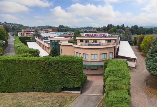 a building with a sign on the top of it at Dreamhotel in Appiano Gentile