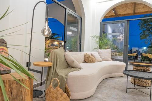 a living room with a white couch and a table at Cabana Blu Hotel & Suites in Kardamaina