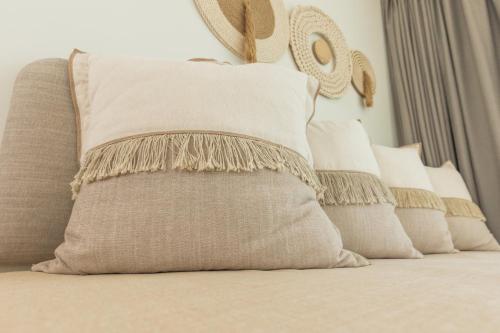 a group of pillows sitting on a bed at Cabana Blu Hotel & Suites in Kardamaina
