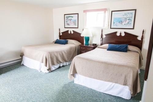 a hotel room with two beds and a window at The Garrison in Wells