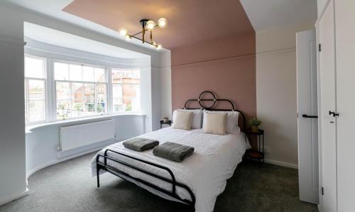 a bedroom with a bed with two pillows on it at The Penthouse in Cromer