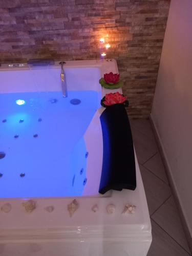 a jacuzzi tub in a room with a table at Mary Gery's Rooms in Castellammare del Golfo
