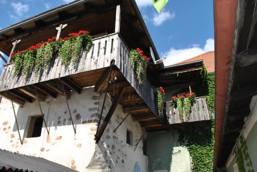 ein Gebäude mit roten Blumen auf dem Balkon in der Unterkunft Gasthof Schwarzer Adler in Nabburg