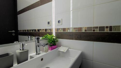 a bathroom with a sink and a mirror at Warm Family Snug in Budapest