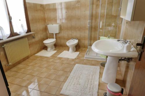 a bathroom with a sink and a toilet and a shower at La casa di Mario e Olga in San Martino