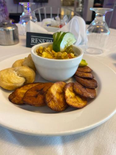 a plate of food with a bowl of food at Jamaica Palace Hotel in Port Antonio