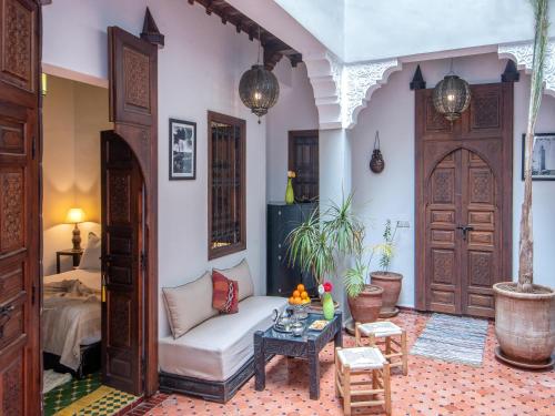 a living room with a couch and a table at Riad Sun of Kech in Marrakesh