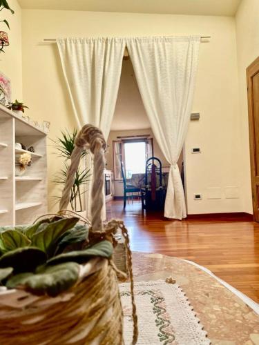 a living room with a bed and a room with a table at La casina del Poggio in Buonconvento
