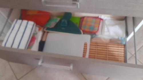 a shelf with books and other items on it at Casa Lucy in Ercolano