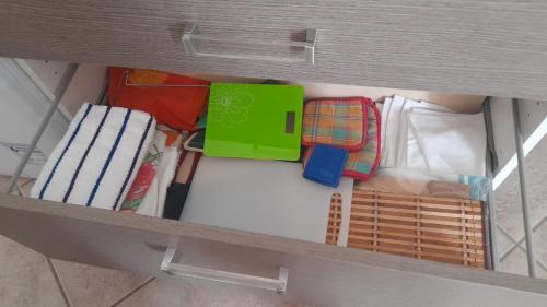 a shelf with different types of items in a drawer at Casa Lucy in Ercolano