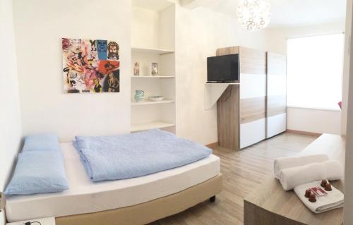 a small bedroom with a bed and a tv at Rosengarten in Bolzano