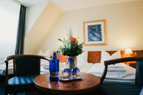 Una habitación de hotel con una mesa con dos botellas. en Altstadt Hotel St. Georg en Düsseldorf