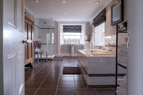 a large bathroom with a sink and a tub at Blanerne House in Duns