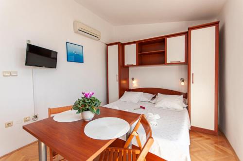 a small room with a table and a bed at Apartments and Rooms Nikola in Omiš