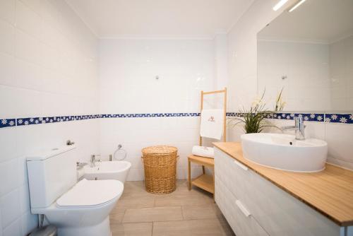 Un baño con un inodoro blanco y un lavabo. en Monte Sossego by Estilo Lusitano, com piscina privada, en Grândola