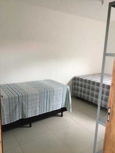 a bedroom with two beds and a ladder at Casa de Praia Tamandare in Tamandaré