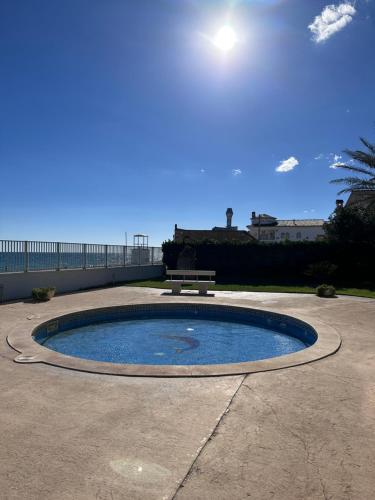 a small pool of water with a bench next to it at Mont-Roig Del Camp in Tarragona