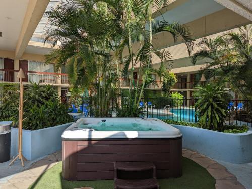 a hot tub in the middle of a building with palm trees at Red Roof Inn PLUS+ Wichita East in Wichita