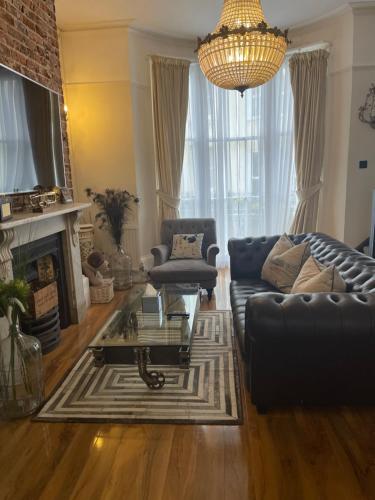 a living room with a couch and a coffee table at Beautiful Seaview 2 Bedroom Apartment in Brighton & Hove