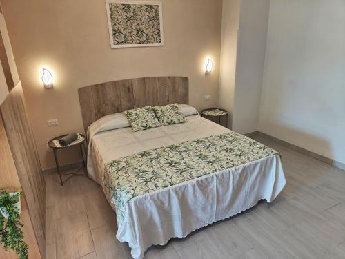 a bedroom with a large bed with a wooden headboard at Ninfea Apartment in Vico Equense