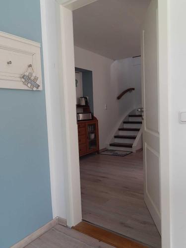 an empty hallway with a staircase in a house at Ferienwohnungen Bekperle in Bekdorf