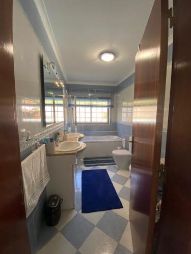 a bathroom with two sinks and a tub and a toilet at Quinta Casal da Eva in Alcobaça