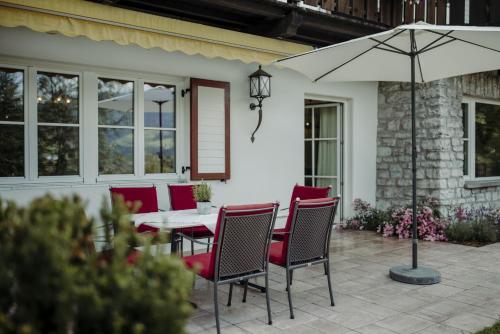 a table and chairs with an umbrella on a patio at Chalet Lerch in Sankt Johann im Pongau