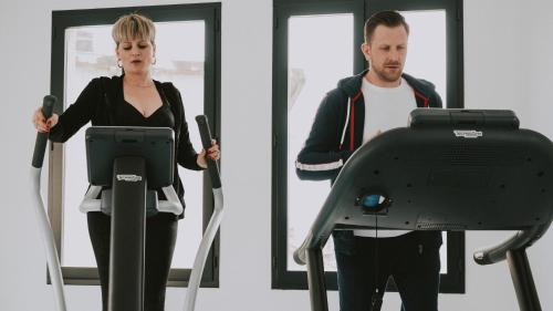 a man and a woman exercising on a treadmill at Urban Style LES FLEURINES in Villefranche-de-Rouergue