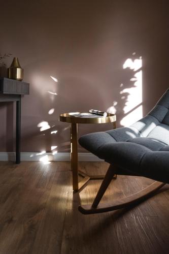 a living room with a chair and a table at Hotel Schloss Neetzow in Neetzow
