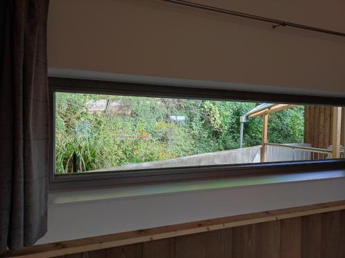 a window in a room with a view of a garden at Ferienhaus am Himberg in Straden