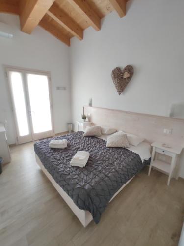 a white bedroom with a bed and a desk at Agriturismo Honey Farm in Piazzola sul Brenta