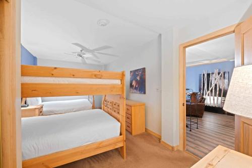 a bedroom with a bunk bed and a desk at St James Place by East West Hospitality in Beaver Creek