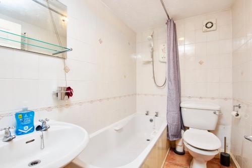 a white bathroom with a toilet and a sink at Perfect Place To Stay Fast Free WiFi in Edinburgh