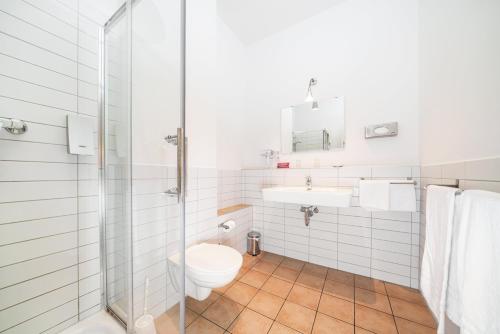 a bathroom with a toilet and a sink and a shower at Hotel 26 in Berlin