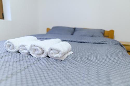 a bed with towels on top of it at Apartman Dina in Soko Banja