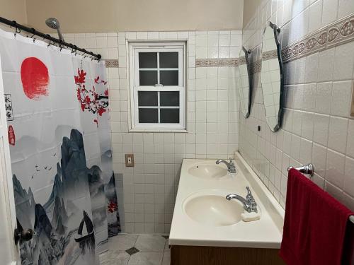 a bathroom with a sink and a shower curtain at Lucky House in Long Beach