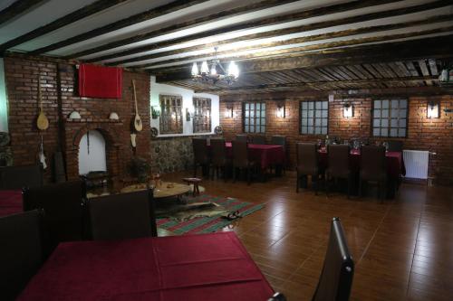 a dining room with tables and chairs in a building at Hotel Antika in Prizren