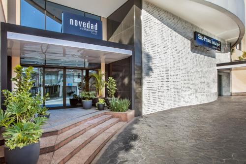 a lobby of a building with potted plants at São Paulo Tatuape, Affiliated by Meliá in Sao Paulo