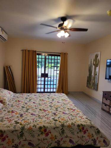 a bedroom with a bed and a ceiling fan at CORONADO, LAS BRISAS in Playa Coronado