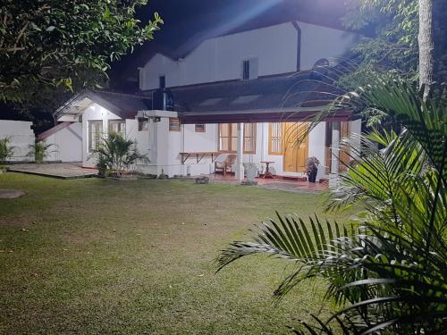 a white house with a yard in front of it at 1906 Park View in Anuradhapura