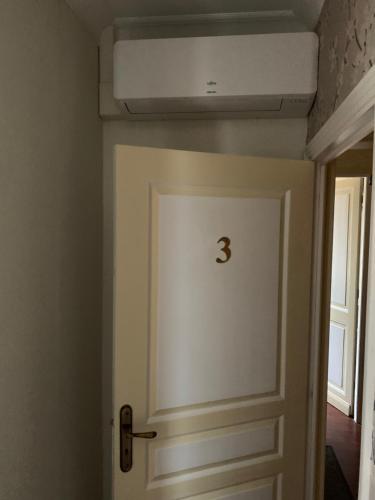 a door with a number on it in a room at Le Pontet in Miramont-de-Guyenne