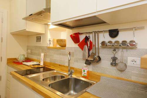 a kitchen with a sink and a counter top at Siena UpTown - Sabrina's Cozy Apartment in Siena