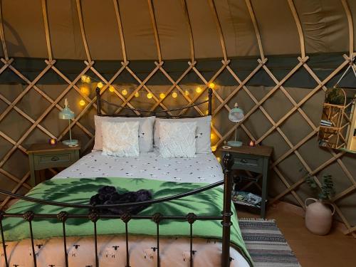 a bedroom with a bed in a yurt at Thistlebank Yurt in Llangollen