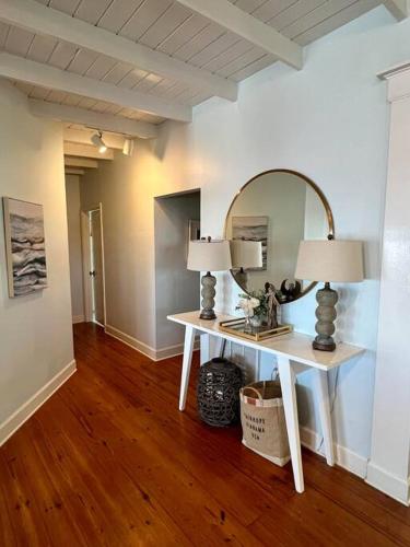 a room with a table with two lamps and a mirror at Write on the Bay, a Waterfront Retreat in Coastal Alabama in Fairhope