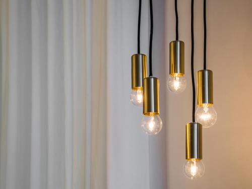 a group of lights hanging from a wall at Alfieri9 in Florence
