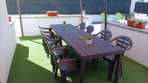 a wooden table and chairs sitting on a patio at Villa Zaira in Baia Verde
