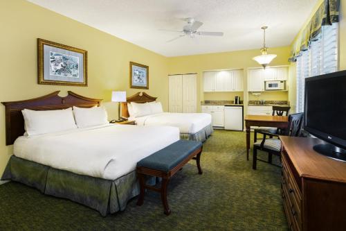 a hotel room with two beds and a flat screen tv at Holiday Inn & Suites Clearwater Beach S-Harbourside in Indian Rocks Beach