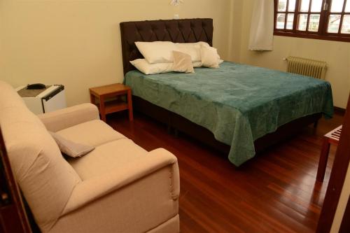 Postel nebo postele na pokoji v ubytování Altos da Serra Hotel