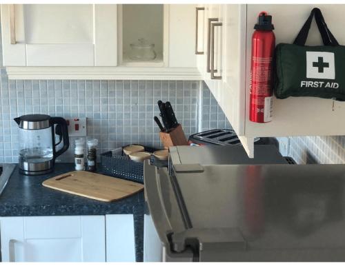 a kitchen with white cabinets and a counter top at Perfectly placed 3 bed home in a peaceful close in Darlington